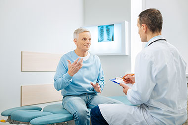 Doctor with patient in exam room