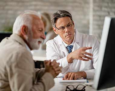 doctor with senior reviewing medicare plans