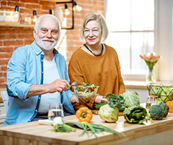 Seniors creating a healthy meal in their kitchen