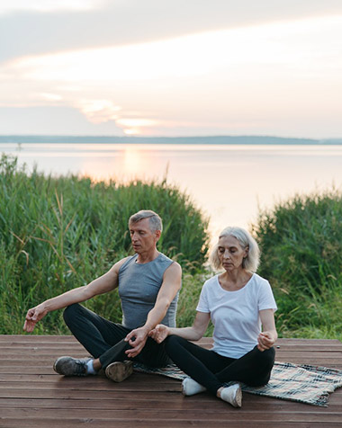 seniors practicing mindfulness while doing yoga outside