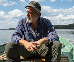 man in boat on a lake in a serene state of mind