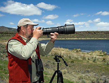 Photographer with long lens on camera