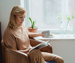 Woman reading by a window