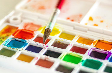 watercolor paints and brush