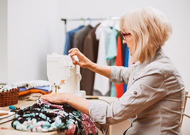 Woman sewing clothes on her sewing machine