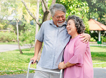 Retired couple walking in park