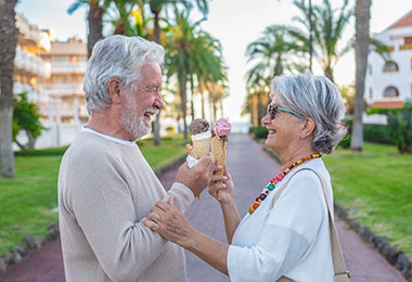 Retired couple enjoying ice cream outside of a retirment community