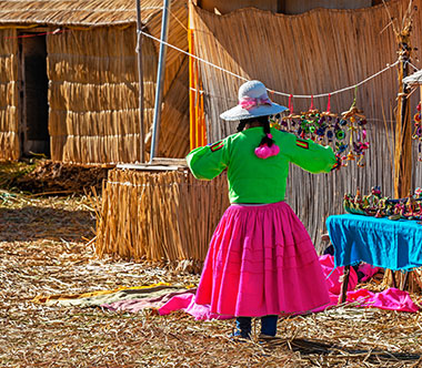Indigenous woman on the Uros floating Islands, Titicaca Lake, Peru